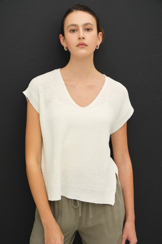dolman sleeve V-neck sweater with a relaxed, cropped silhouette and modern high-low hem