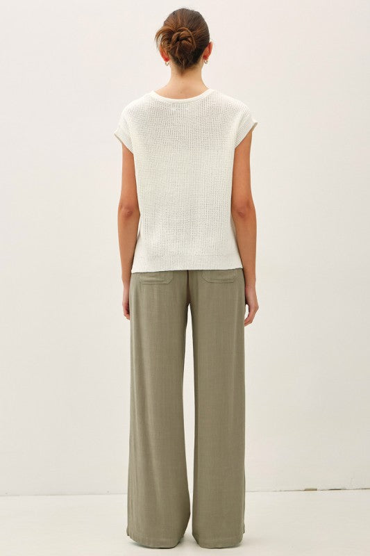 dolman sleeve V-neck sweater with a relaxed, cropped silhouette and modern high-low hem