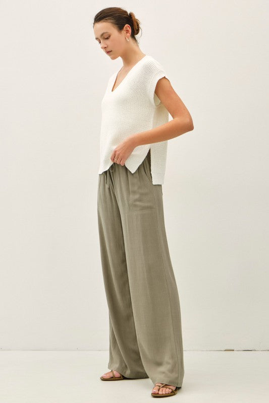 dolman sleeve V-neck sweater with a relaxed, cropped silhouette and modern high-low hem