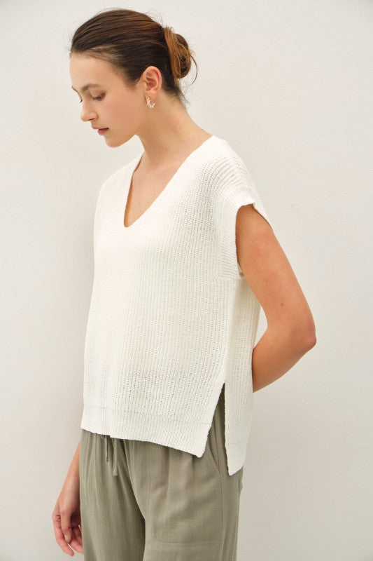 dolman sleeve V-neck sweater with a relaxed, cropped silhouette and modern high-low hem
