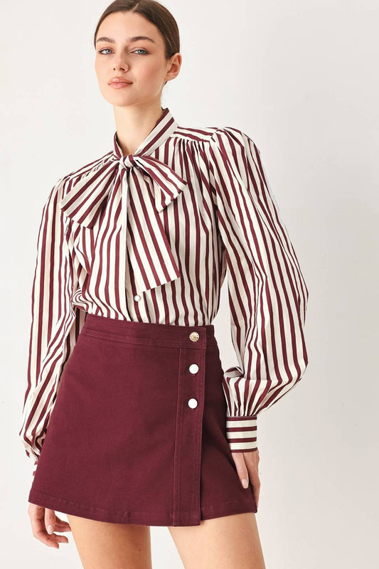 Tailored woven skort featuring a front closure, button detailing, and a flattering silhouette with built-in shorts for comfortable everyday wear.