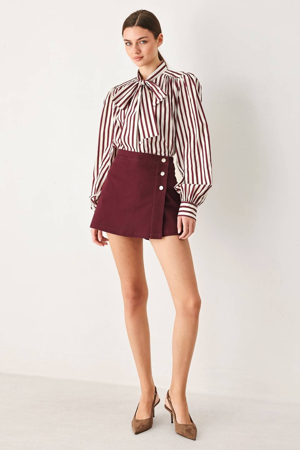 Tailored woven skort featuring a front closure, button detailing, and a flattering silhouette with built-in shorts for comfortable everyday wear.
