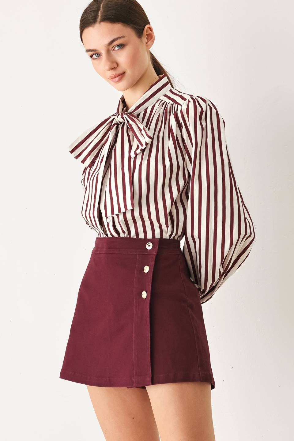 Tailored woven skort featuring a front closure, button detailing, and a flattering silhouette with built-in shorts for comfortable everyday wear.
