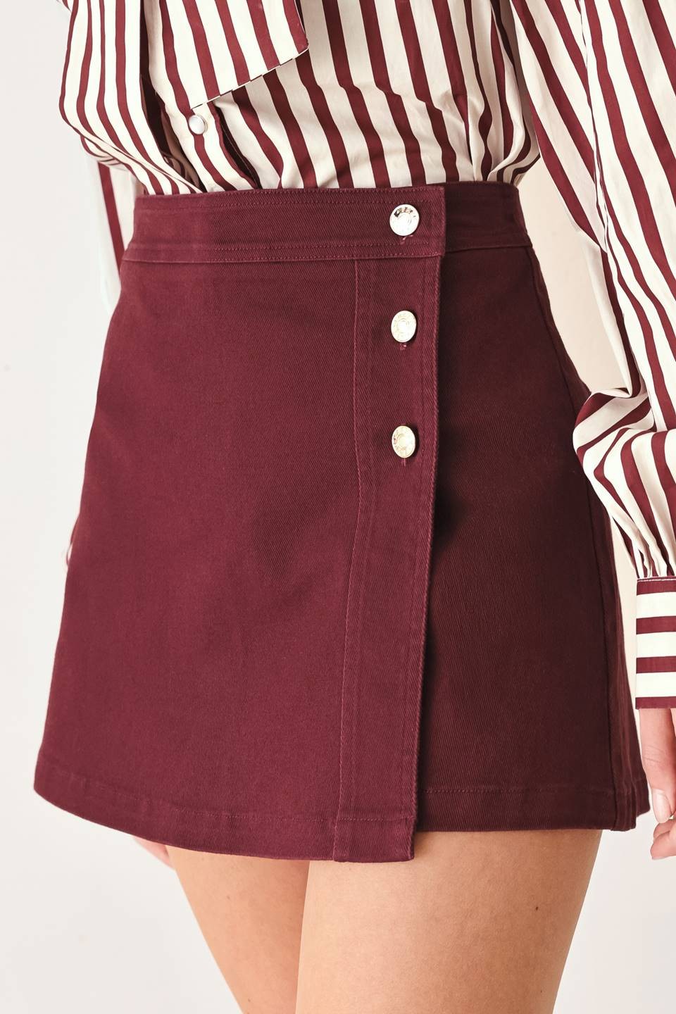 Tailored woven skort featuring a front closure, button detailing, and a flattering silhouette with built-in shorts for comfortable everyday wear.