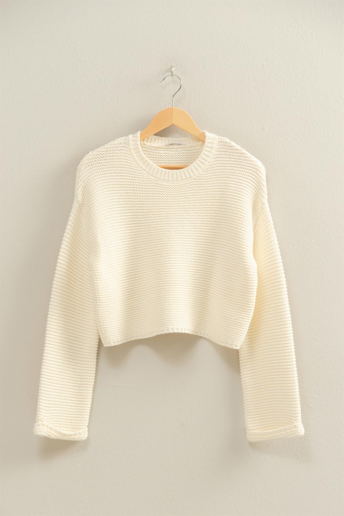 An effortlessly chic textured knit sweater with wide sleeves and a relaxed silhouette for versatile styling.