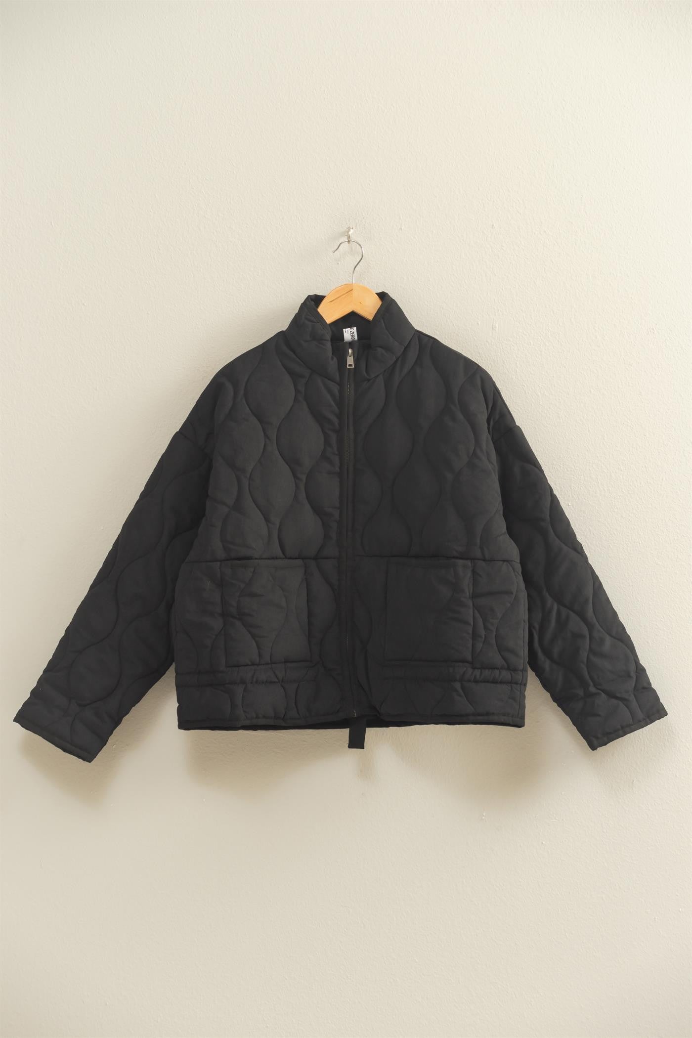 The Evadne Quilted Drawstring Jacket delivers cozy structure with a modern relaxed fit.