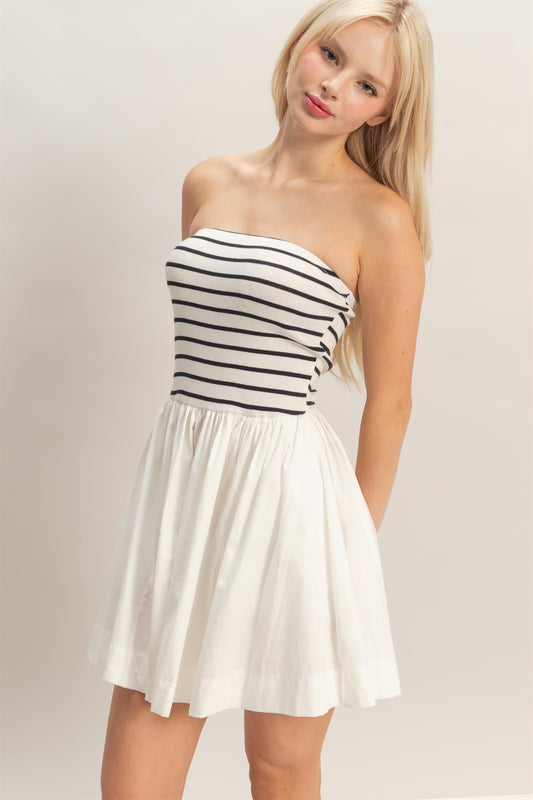 strapless striped mini dress featuring a fitted knit bodice and flowy woven skirt