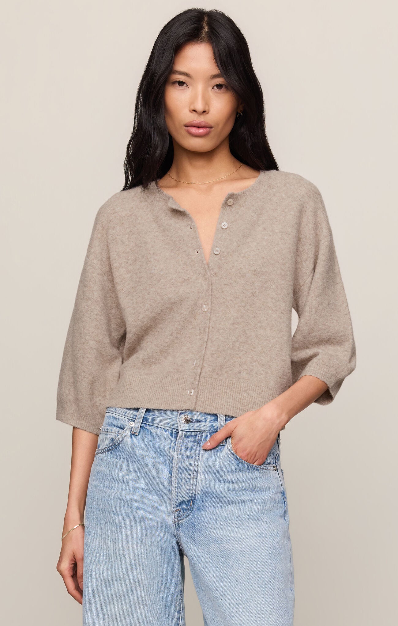 A soft knit button-front top featuring a classic crew neckline, ¾ sleeves, and a lightweight stretch fabric for effortless everyday layering.