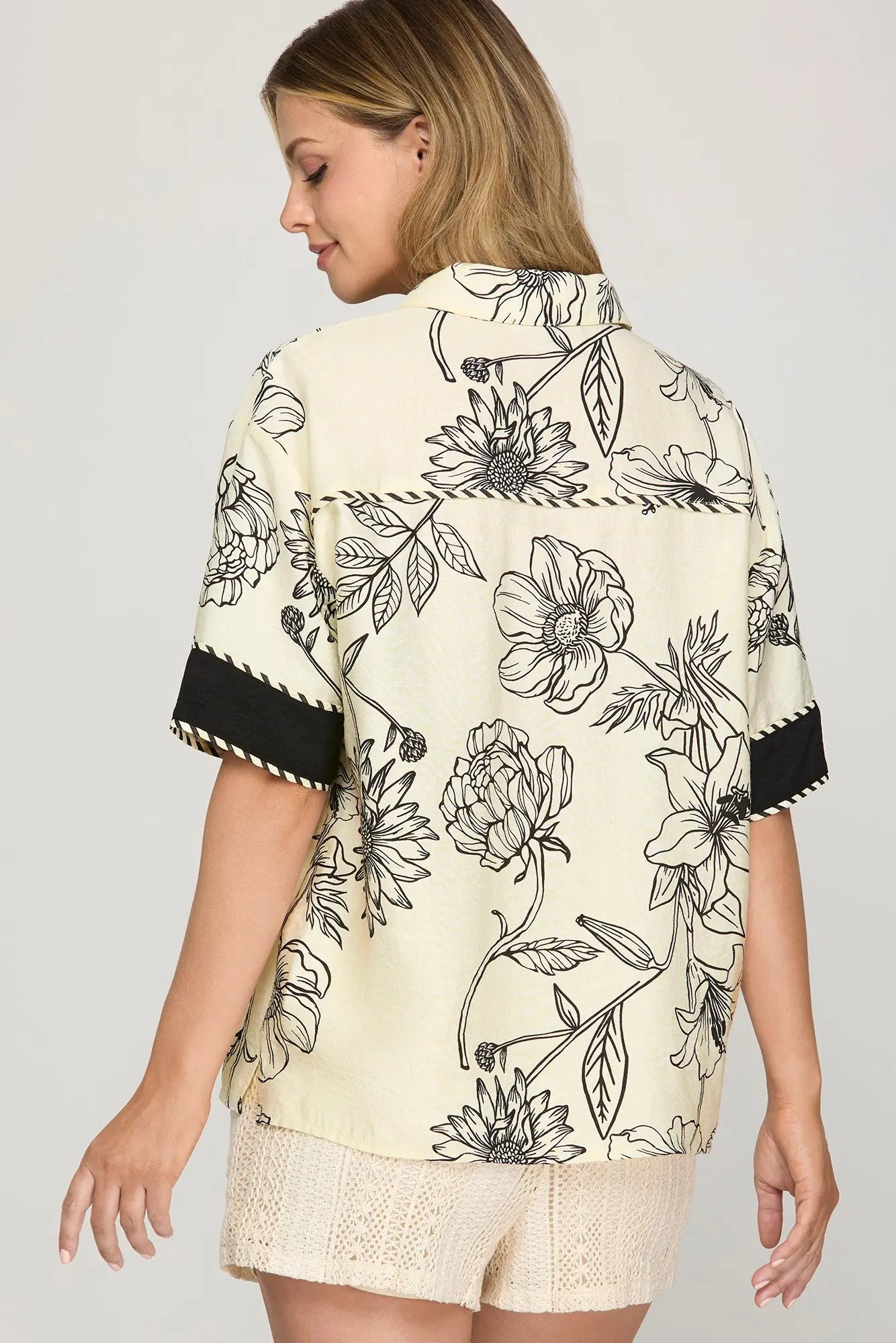 Half sleeve woven printed button-down shirt with contrast trim detailing.