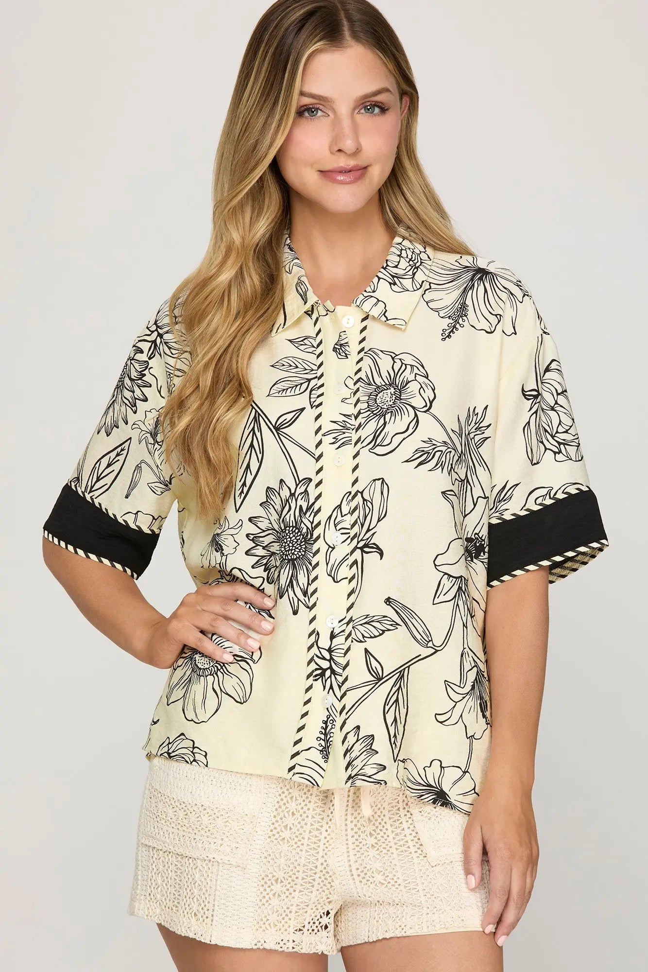 Half sleeve woven printed button-down shirt with contrast trim detailing.