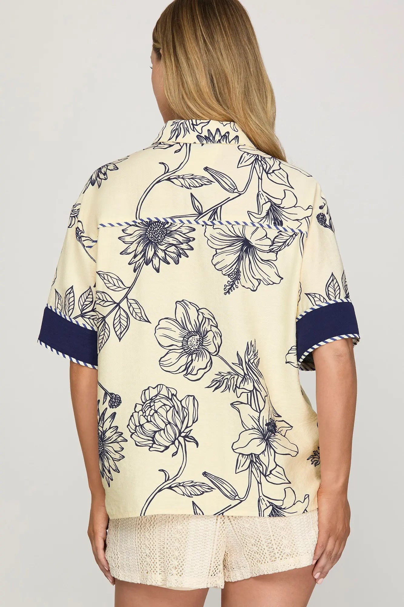 Half sleeve woven printed button-down shirt with contrast trim detailing.