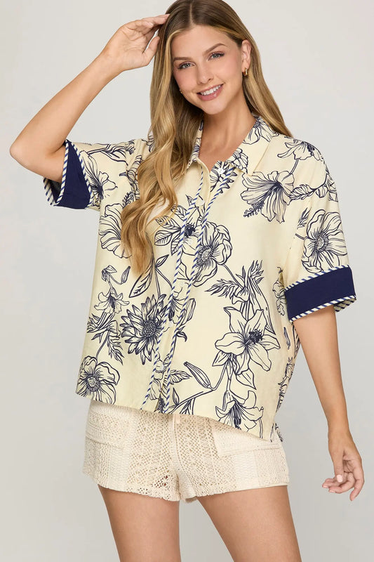 Half sleeve woven printed button-down shirt with contrast trim detailing.