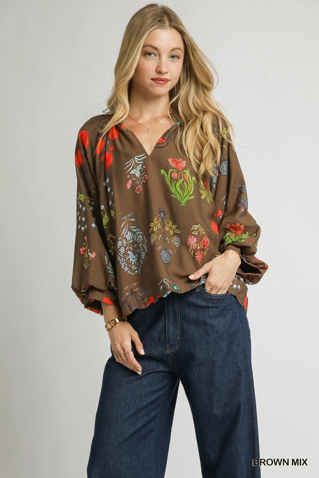 A feminine floral blouse with scalloped details and an easy, relaxed fit—perfect for effortless elegance.