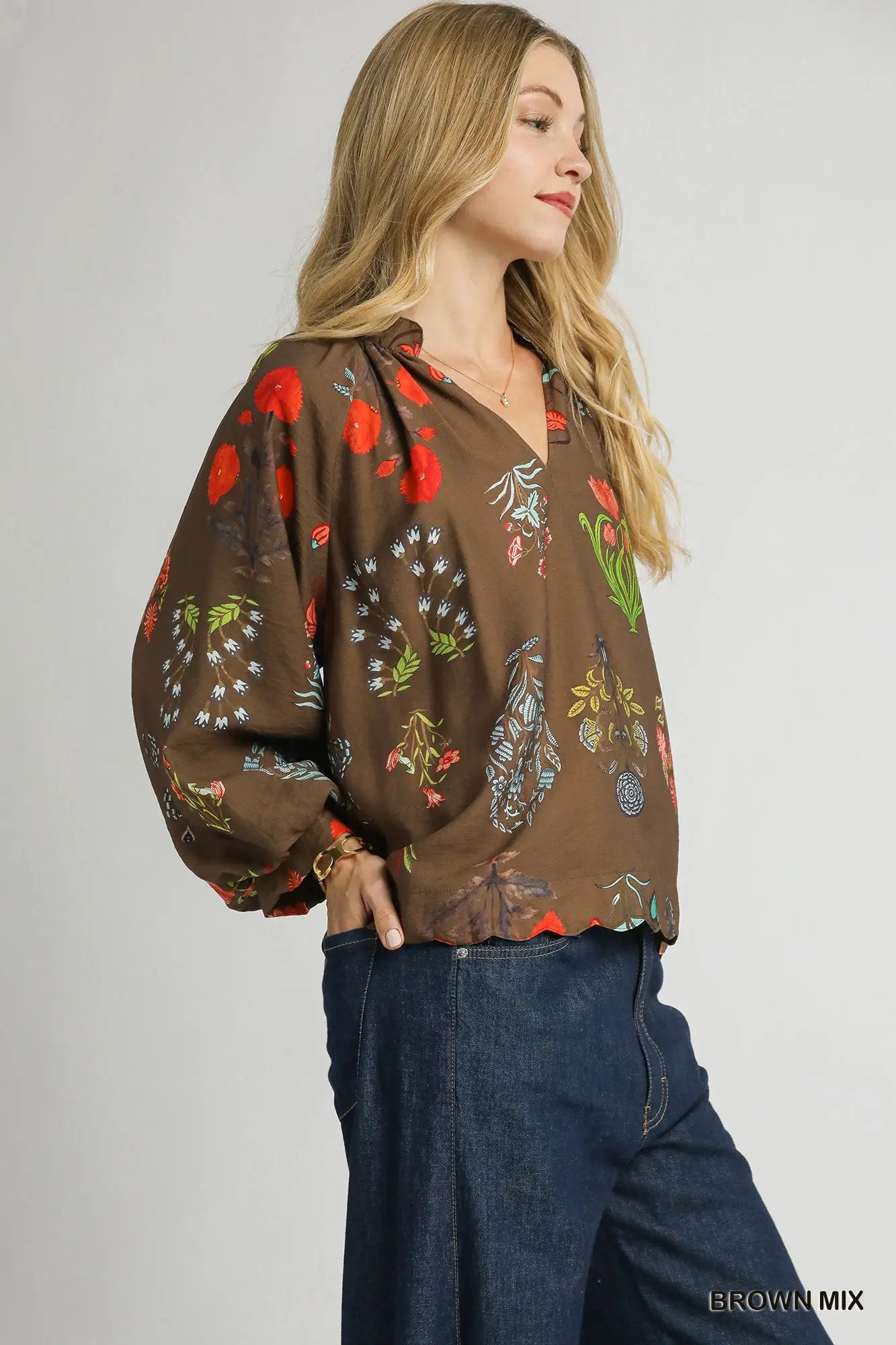 A feminine floral blouse with scalloped details and an easy, relaxed fit—perfect for effortless elegance.