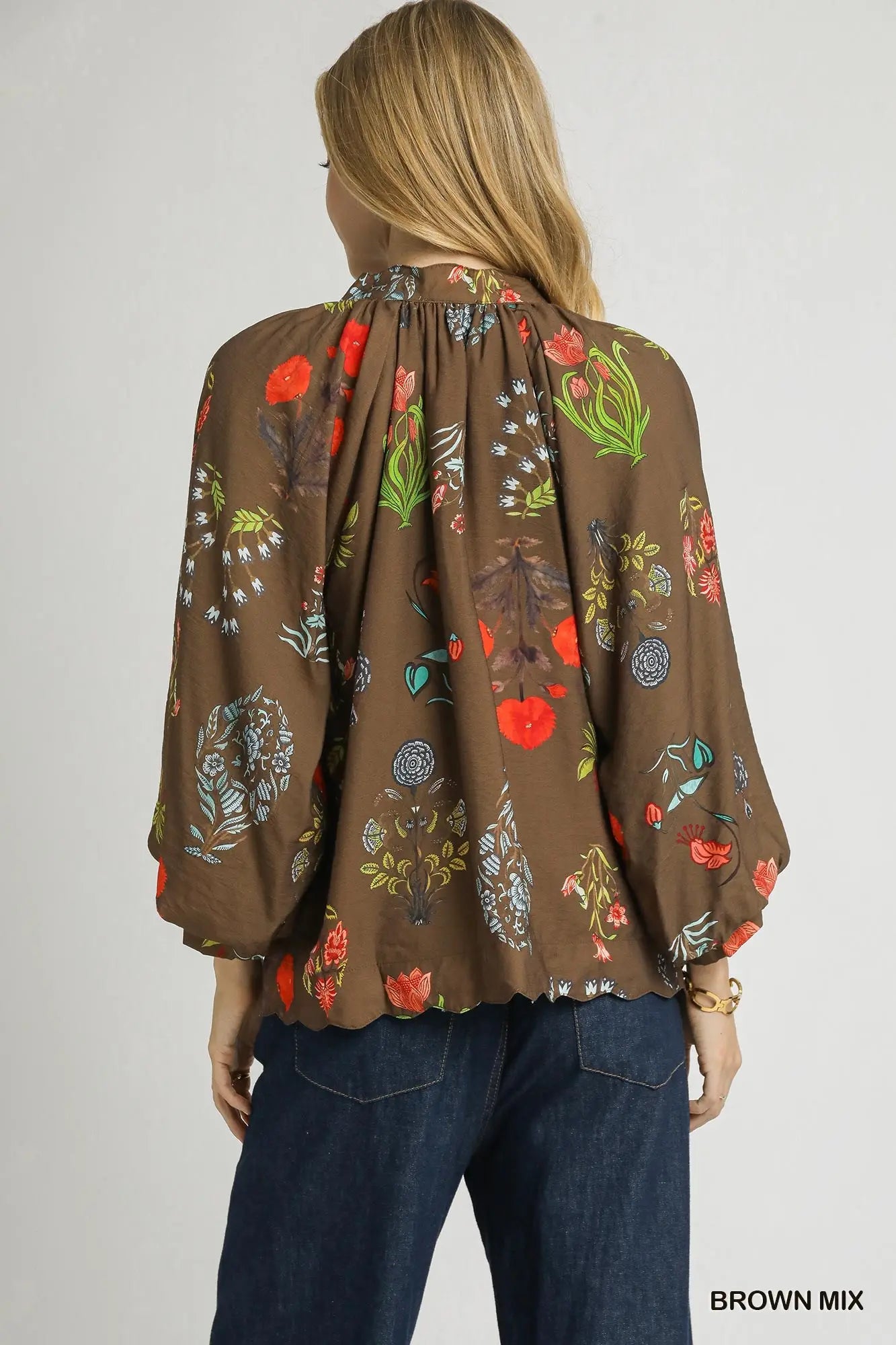 A feminine floral blouse with scalloped details and an easy, relaxed fit—perfect for effortless elegance.