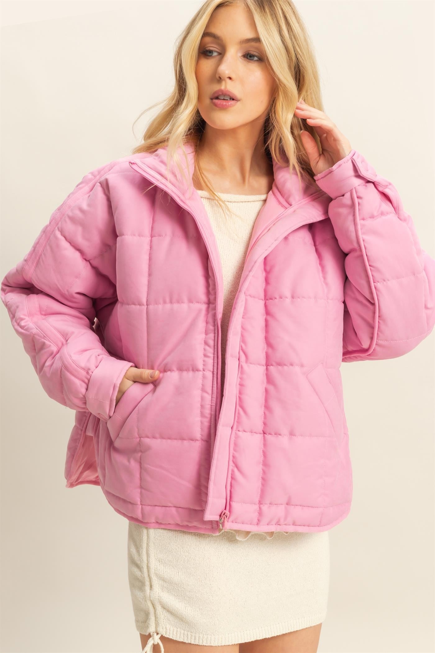 A sophisticated quilted puffer jacket with a stand collar, cozy fit, and timeless style for chilly days.

