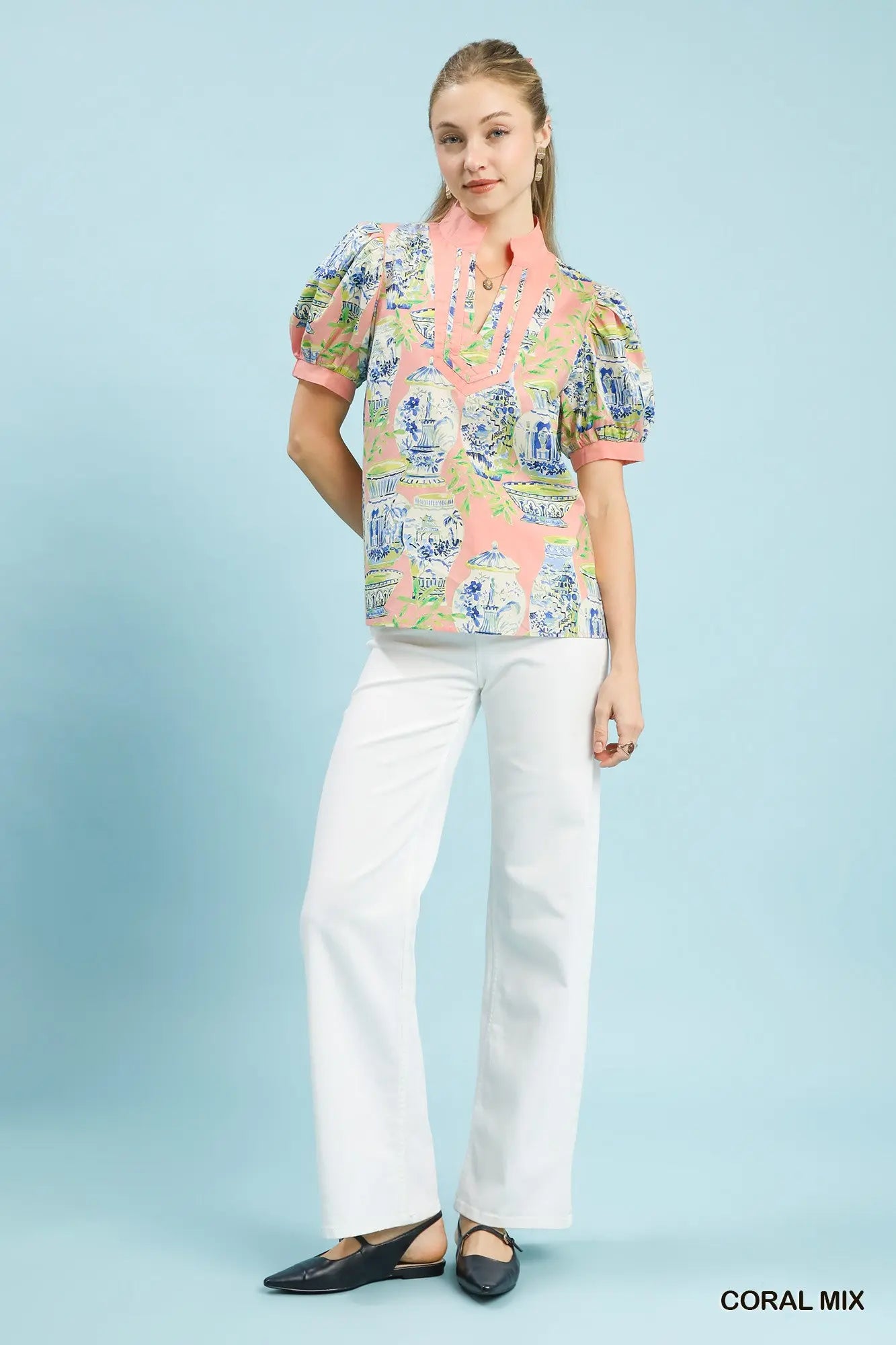cotton top featuring an abstract print, puff sleeves, and contrast trim detailing