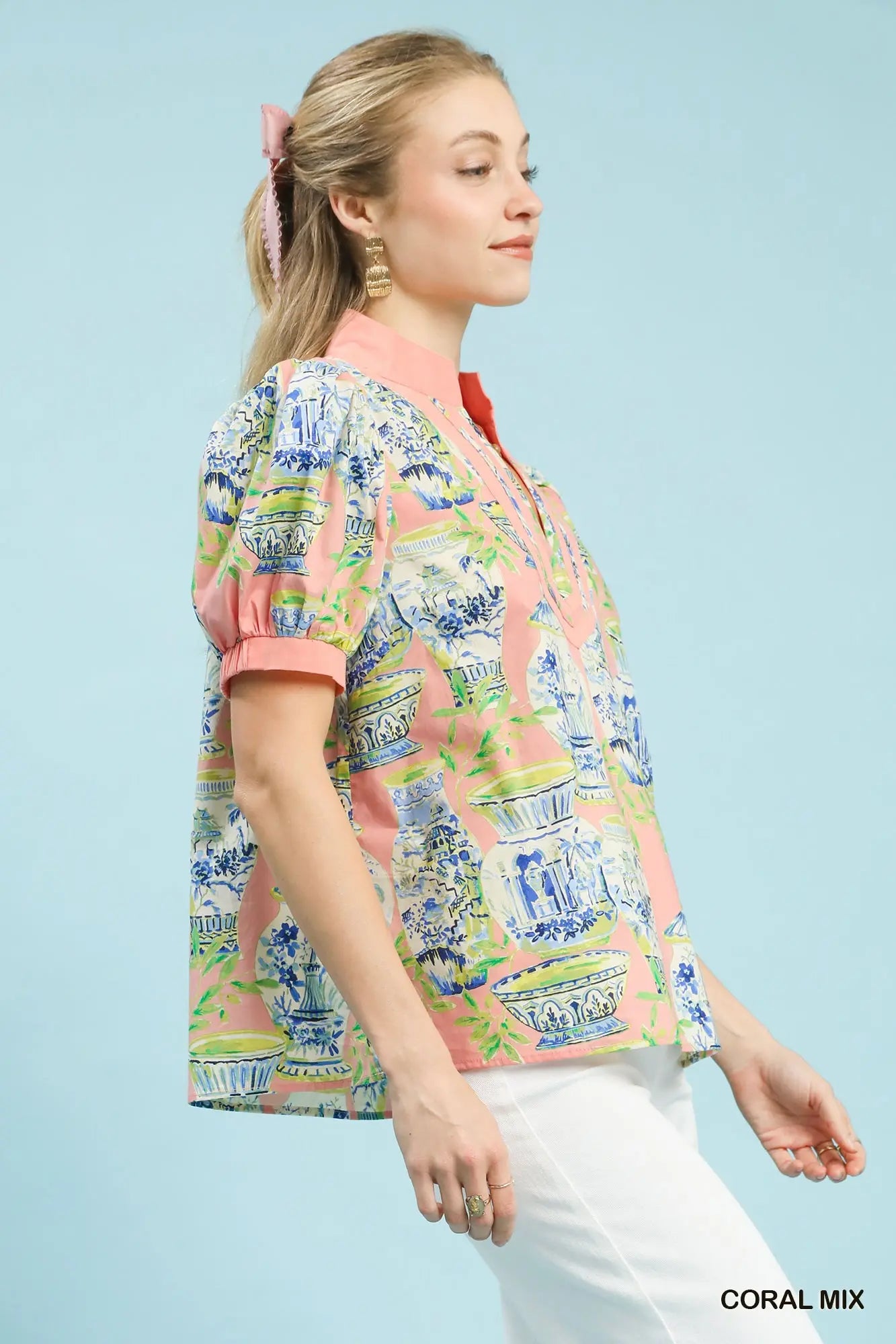 cotton top featuring an abstract print, puff sleeves, and contrast trim detailing