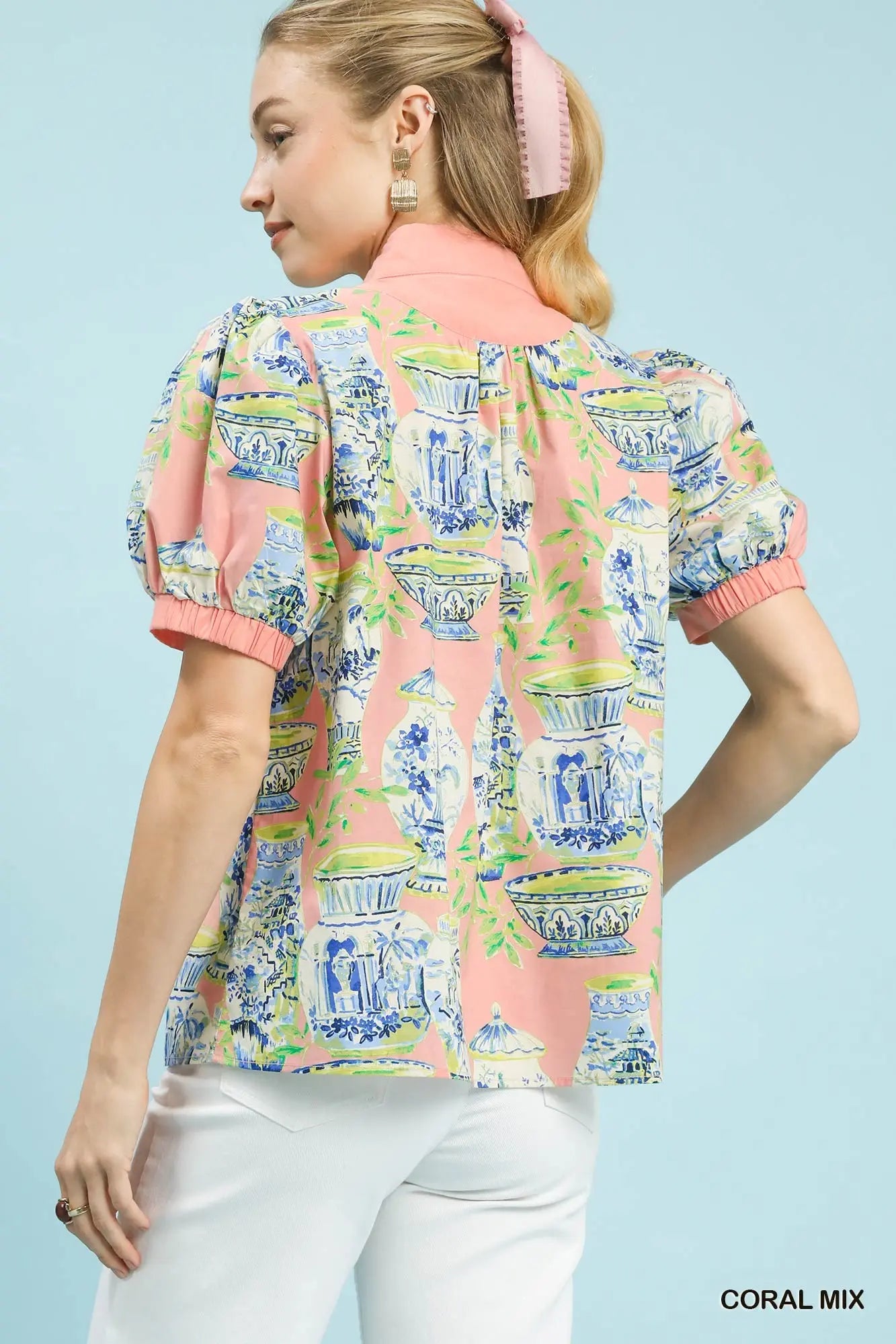 cotton top featuring an abstract print, puff sleeves, and contrast trim detailing