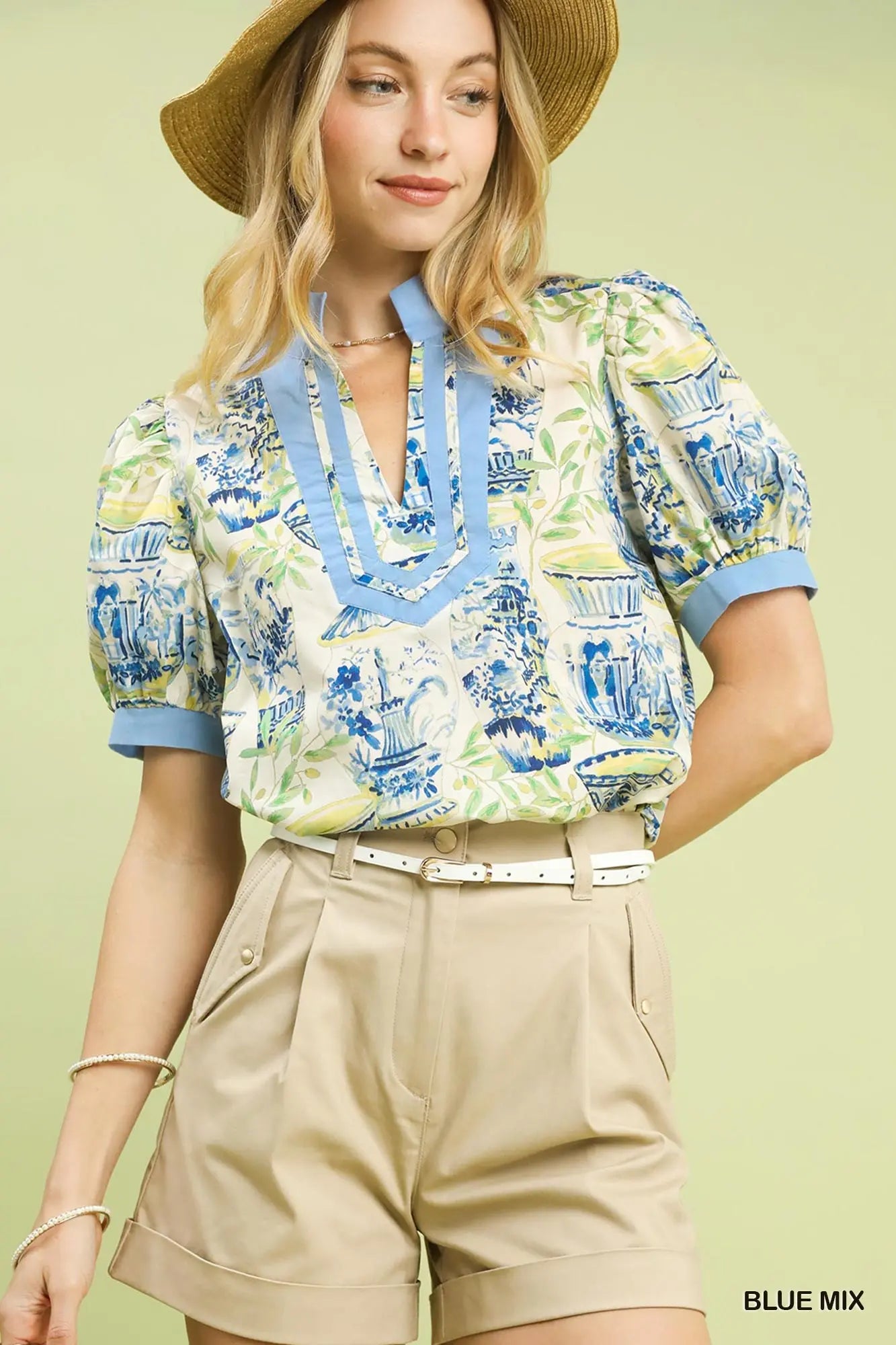 cotton top featuring an abstract print, puff sleeves, and contrast trim detailing