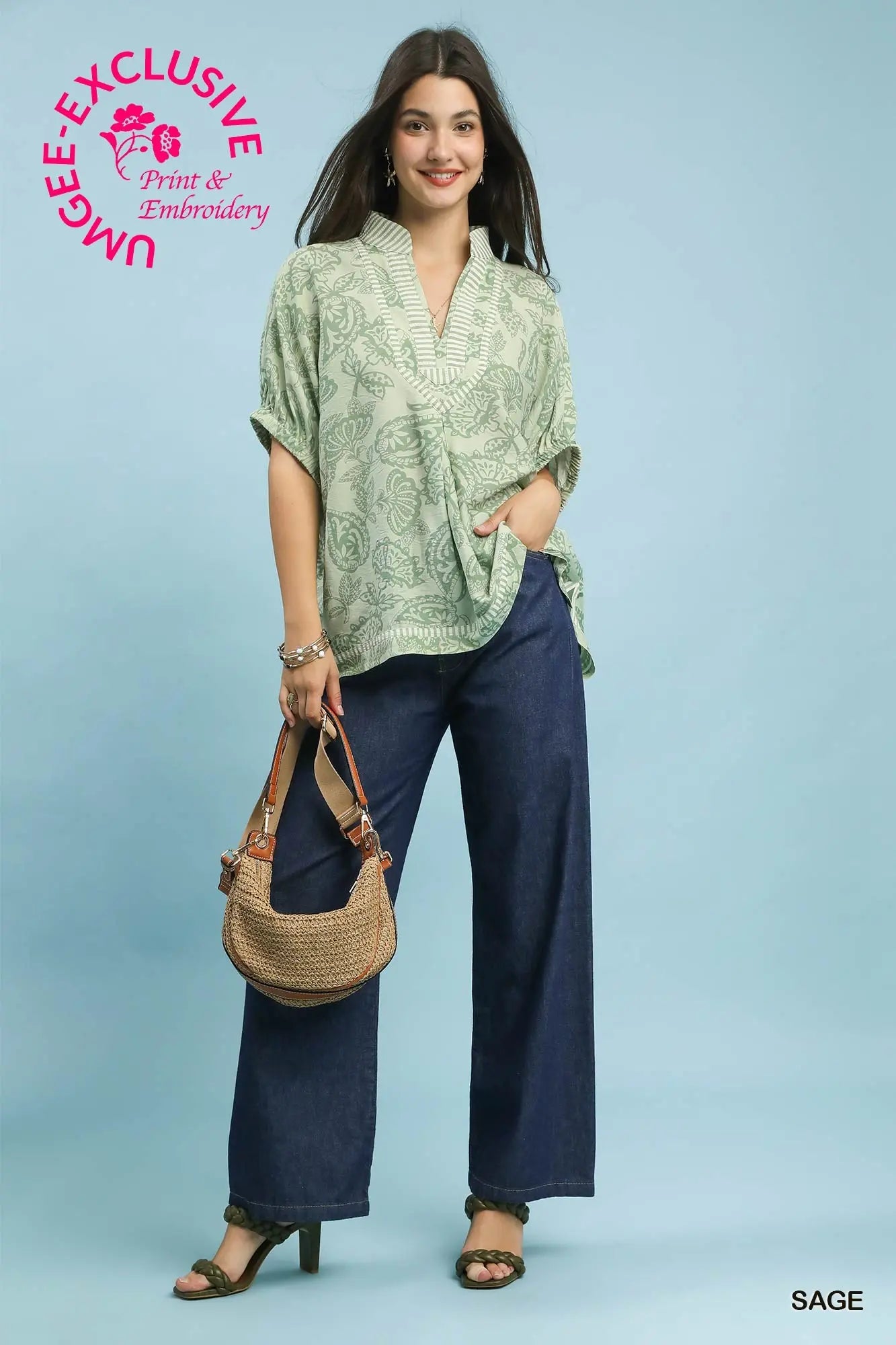 oversized botanical print tunic featuring contrast trim and relaxed dolman sleeves.