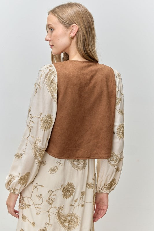 The Lucinda Suede Embroidered Vest adds Western-inspired charm and texture to any look with its soft faux suede and intricate stitching.