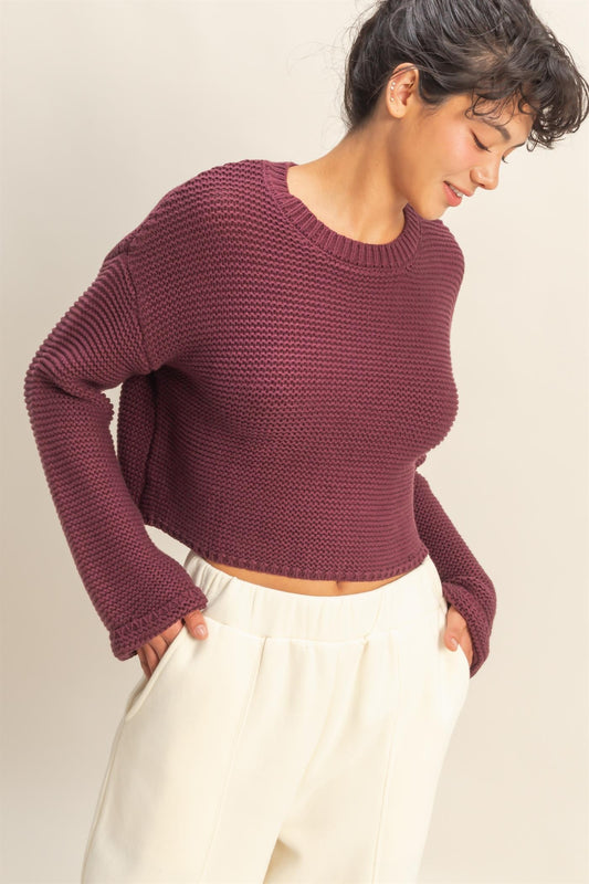 An effortlessly chic textured knit sweater with wide sleeves and a relaxed silhouette for versatile styling.
