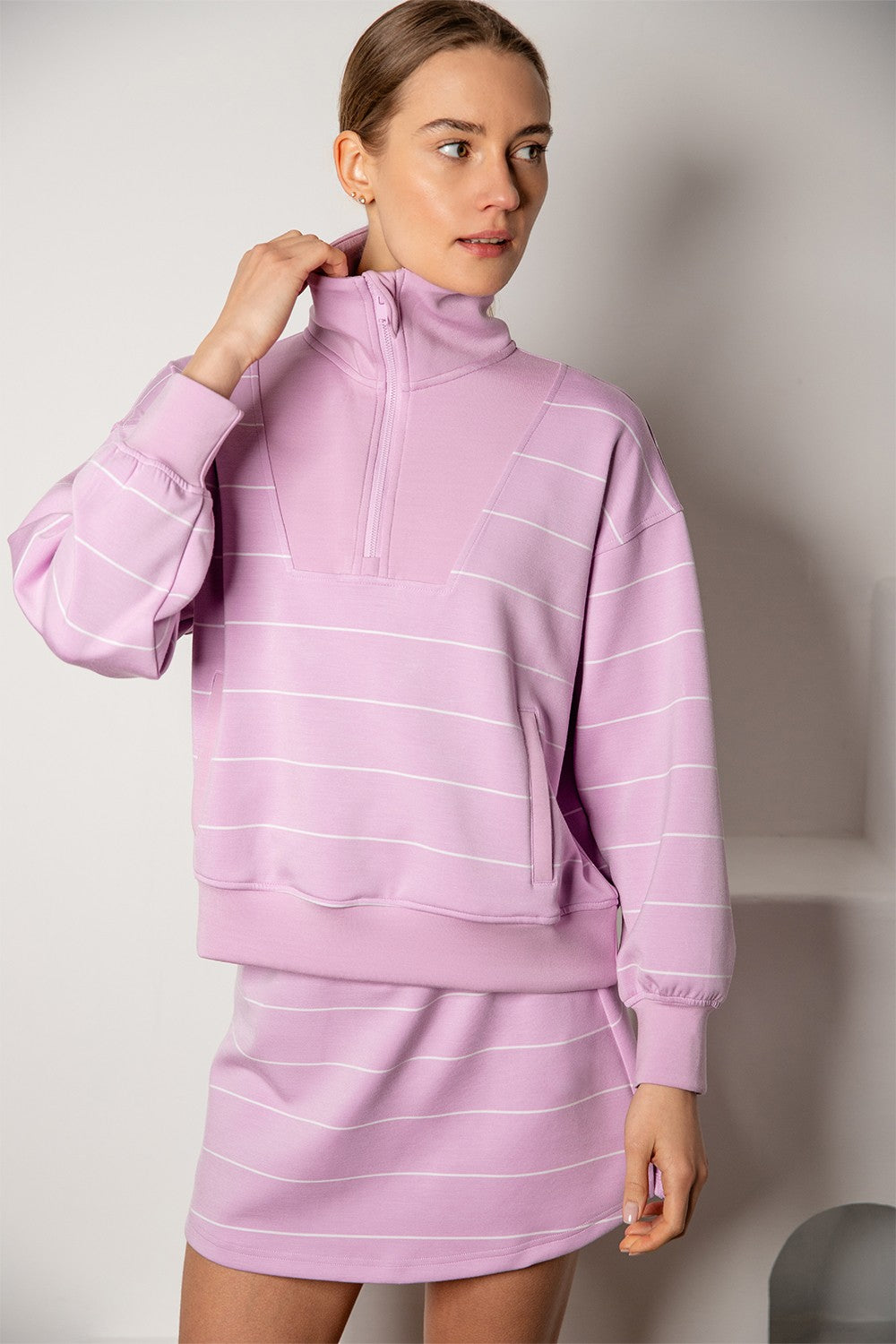 A silky-soft striped pullover with a mock neck, quarter zip, and kangaroo pocket for effortless comfort and style.