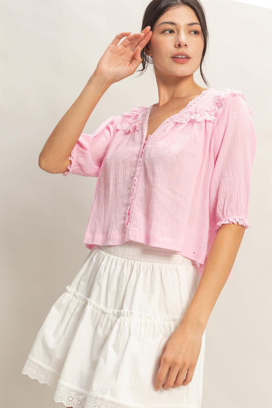  Lace Trim V-Neck Top features delicate ruffled lace accents and a relaxed silhouette 