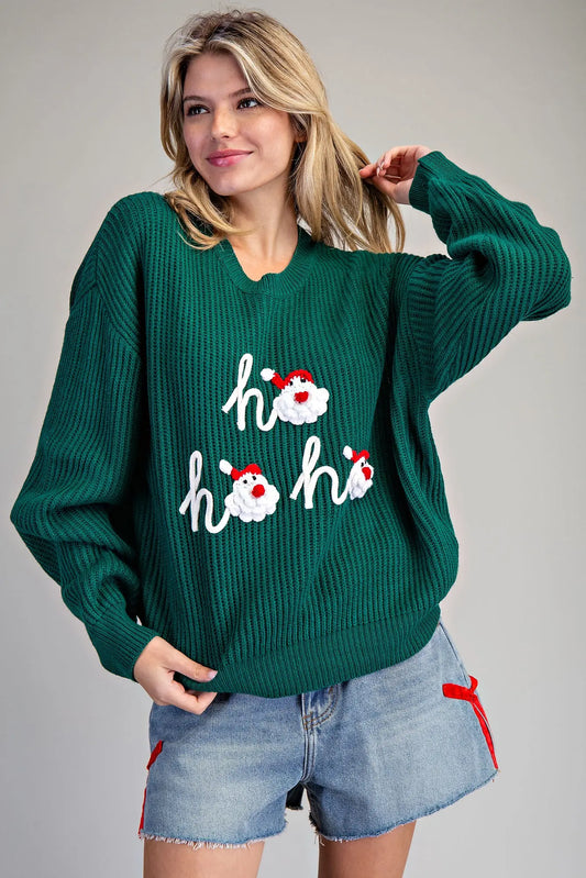A cozy holiday sweater with playful 3D crocheted Santa appliques and festive “ho ho ho” lettering. 🎅✨
