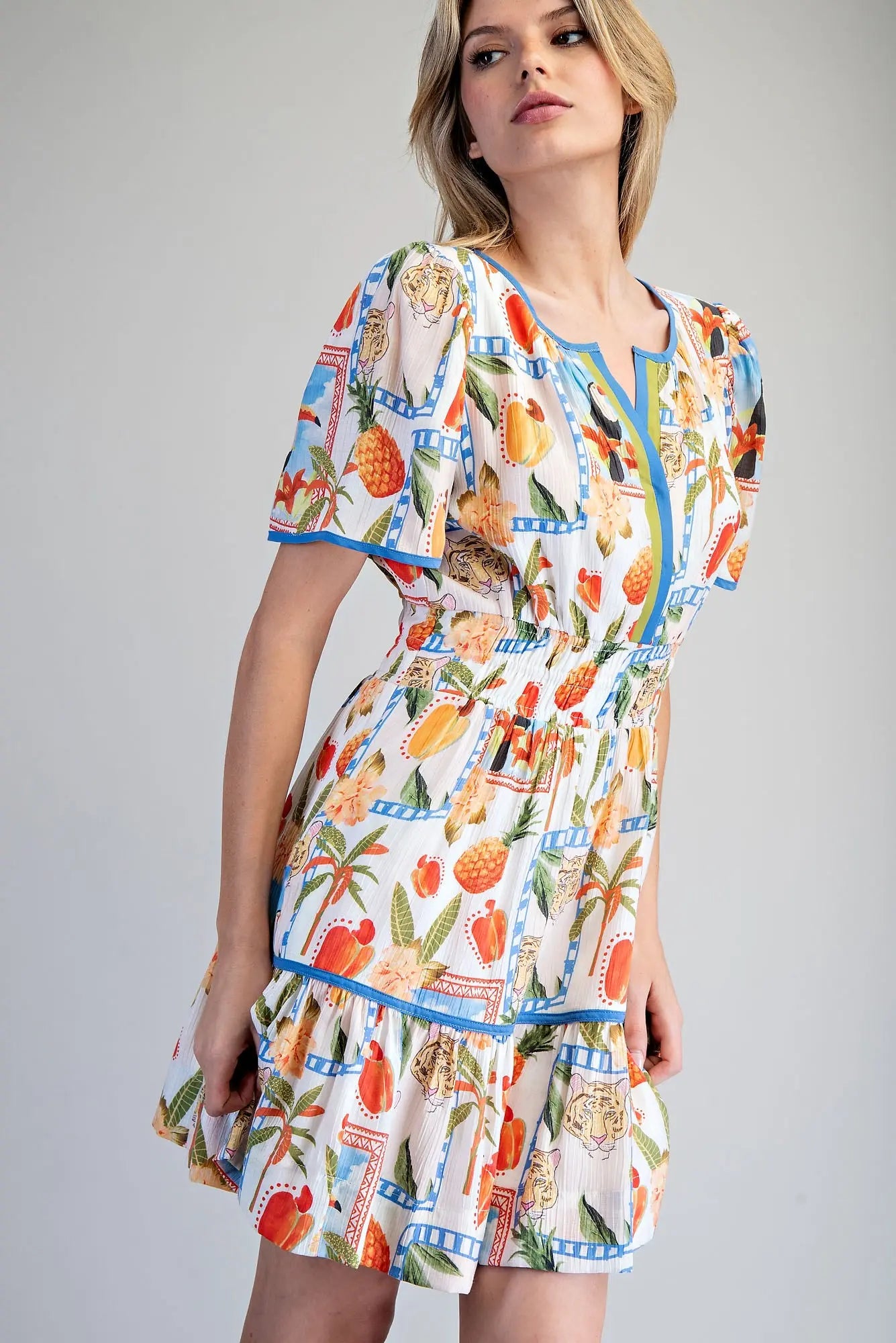 Tropical inspired split v-neck mini dress with smocked waist