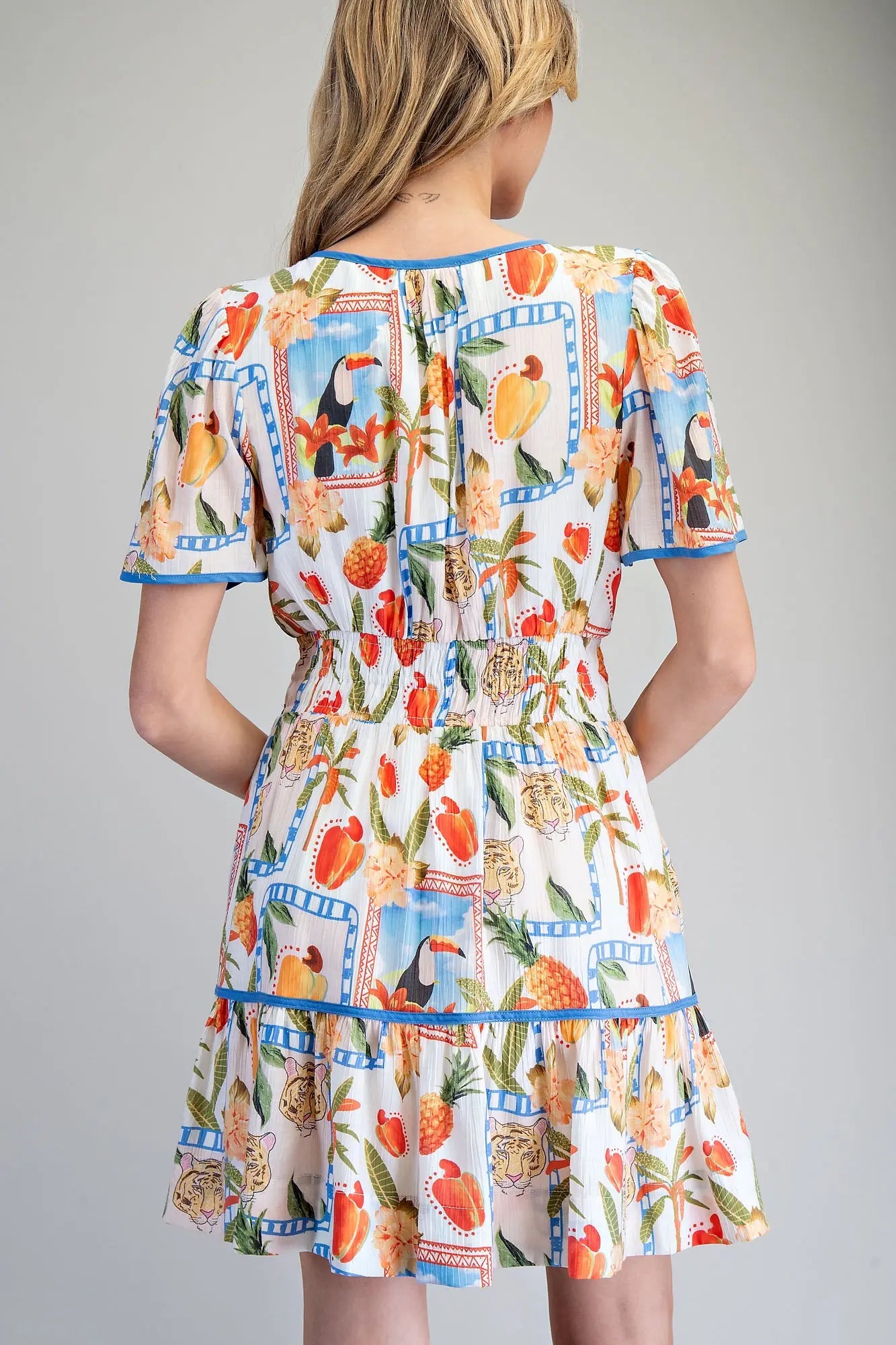 Tropical inspired split v-neck mini dress with smocked waist