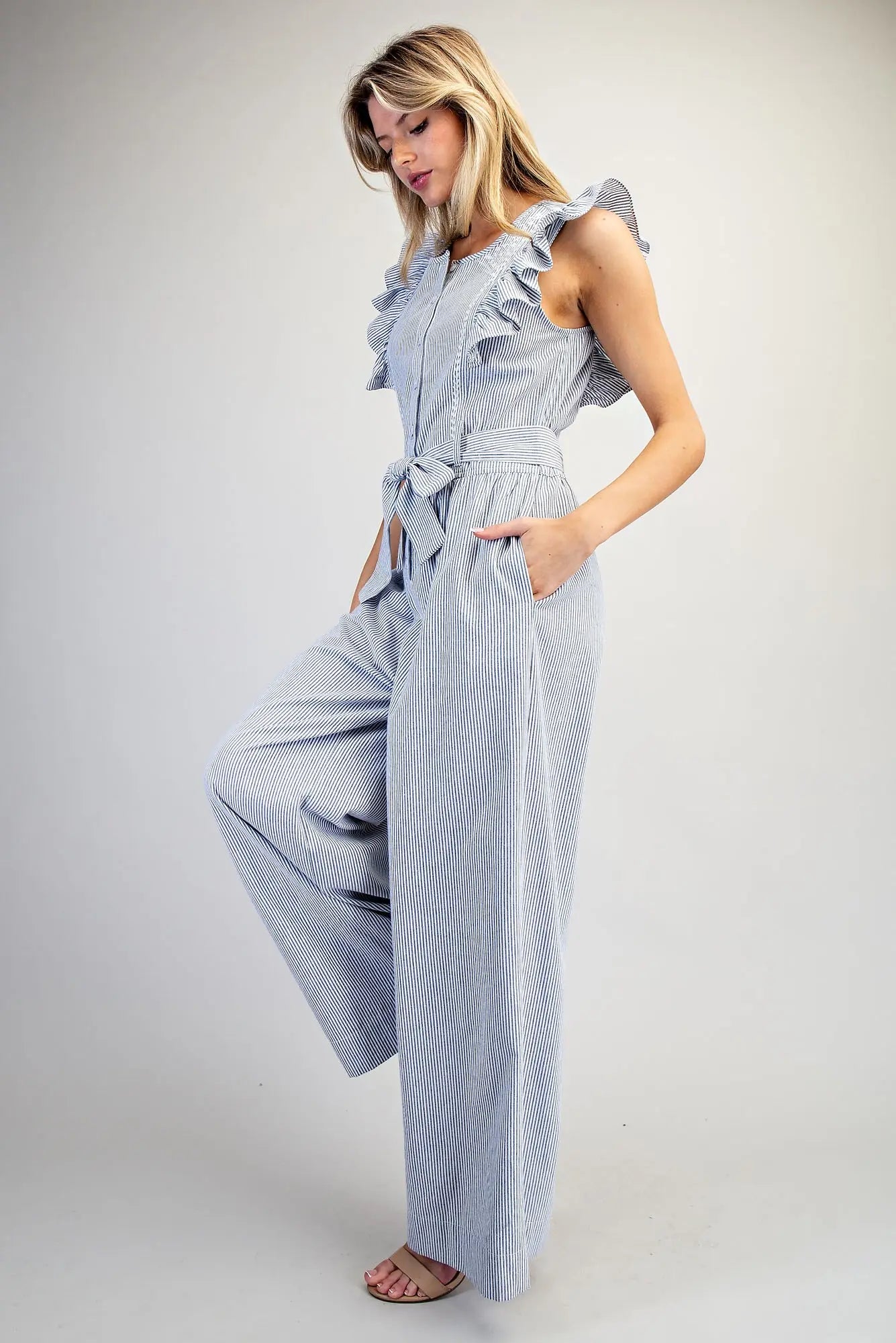 Striped ruffle shoulder jumpsuit with tie waist and wide leg