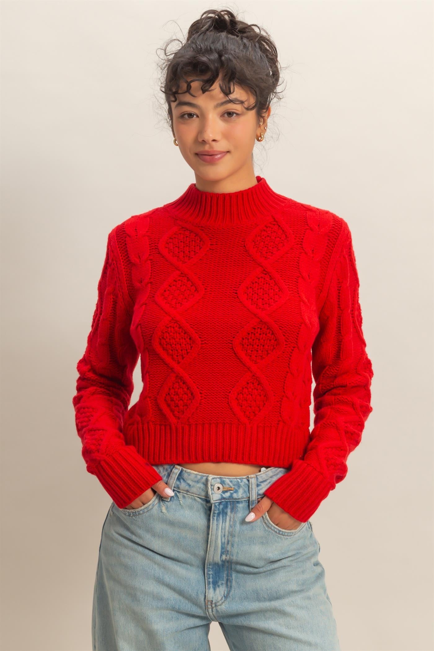 A timeless cable-knit sweater with a cozy, structured silhouette for effortless elegance.