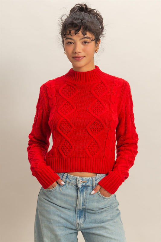 A timeless cable-knit sweater with a cozy, structured silhouette for effortless elegance.