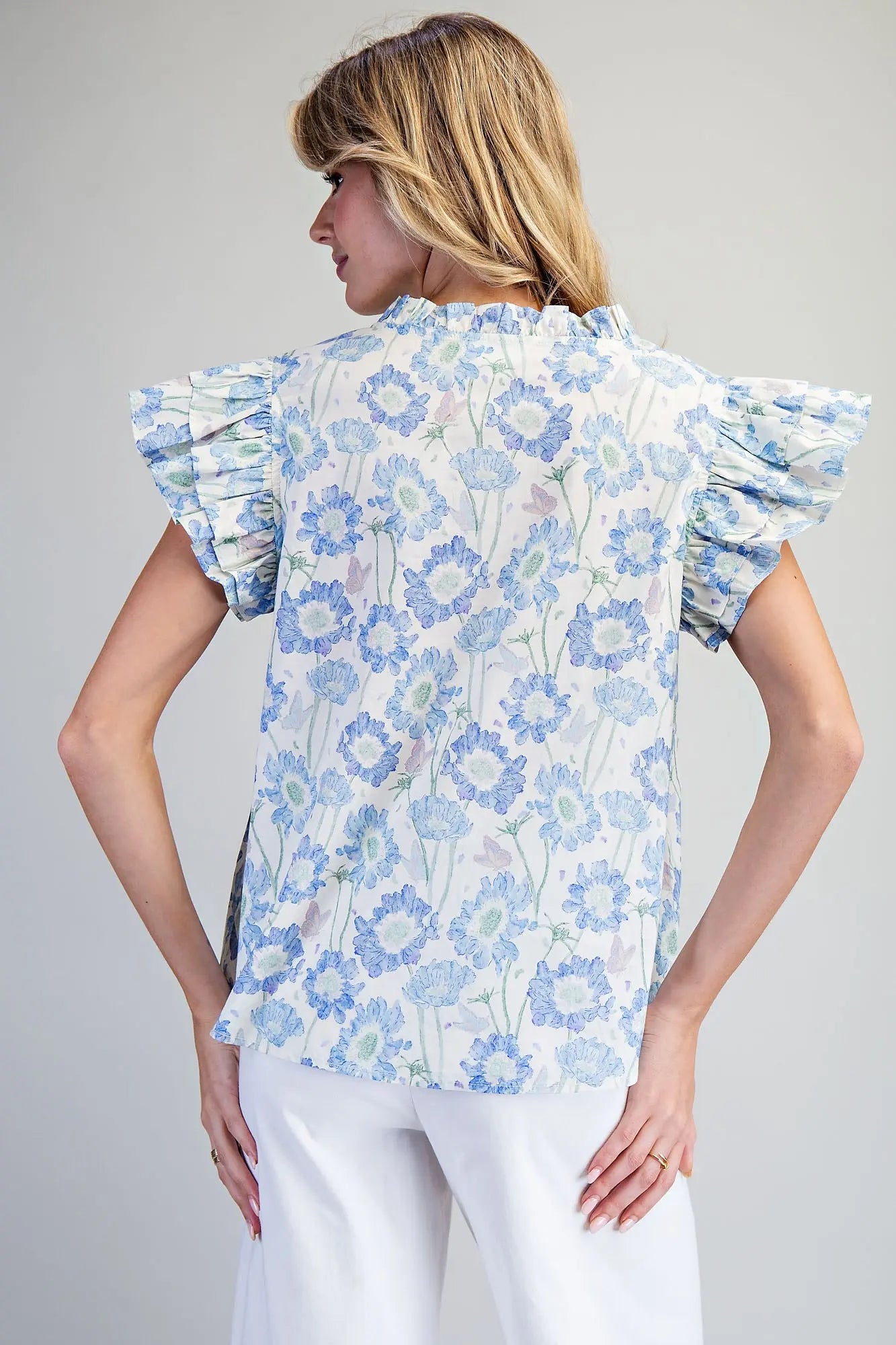 floral cotton top featuring layered flutter sleeves and delicate ruffle trim