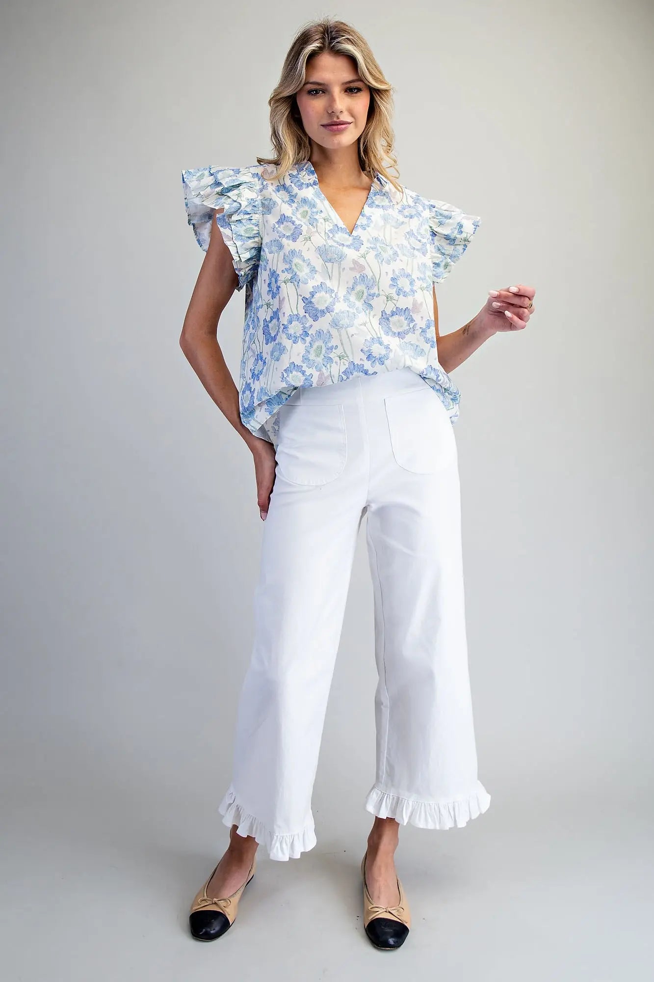 floral cotton top featuring layered flutter sleeves and delicate ruffle trim