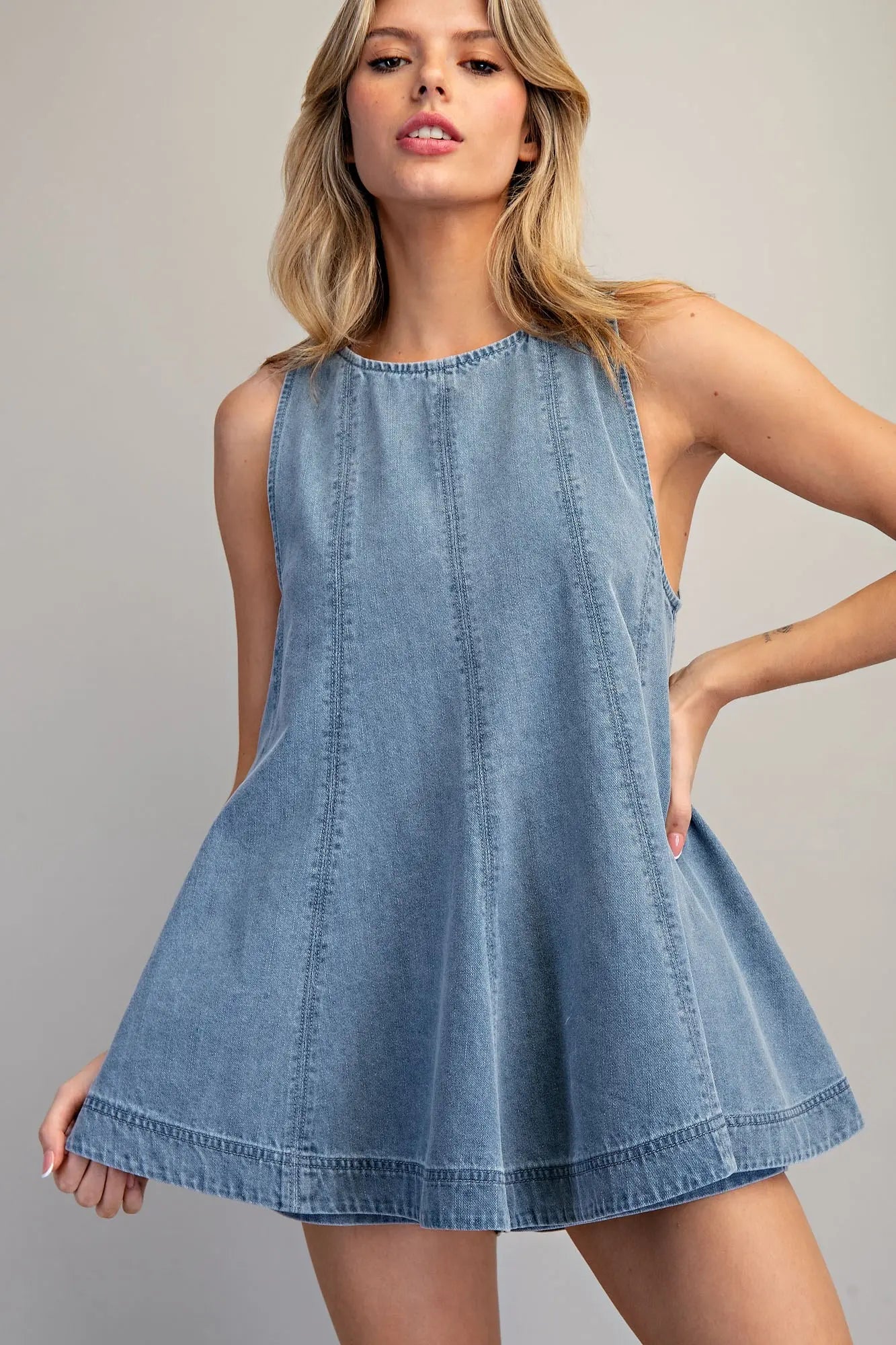 Sleeveless A-line denim top with high neckline