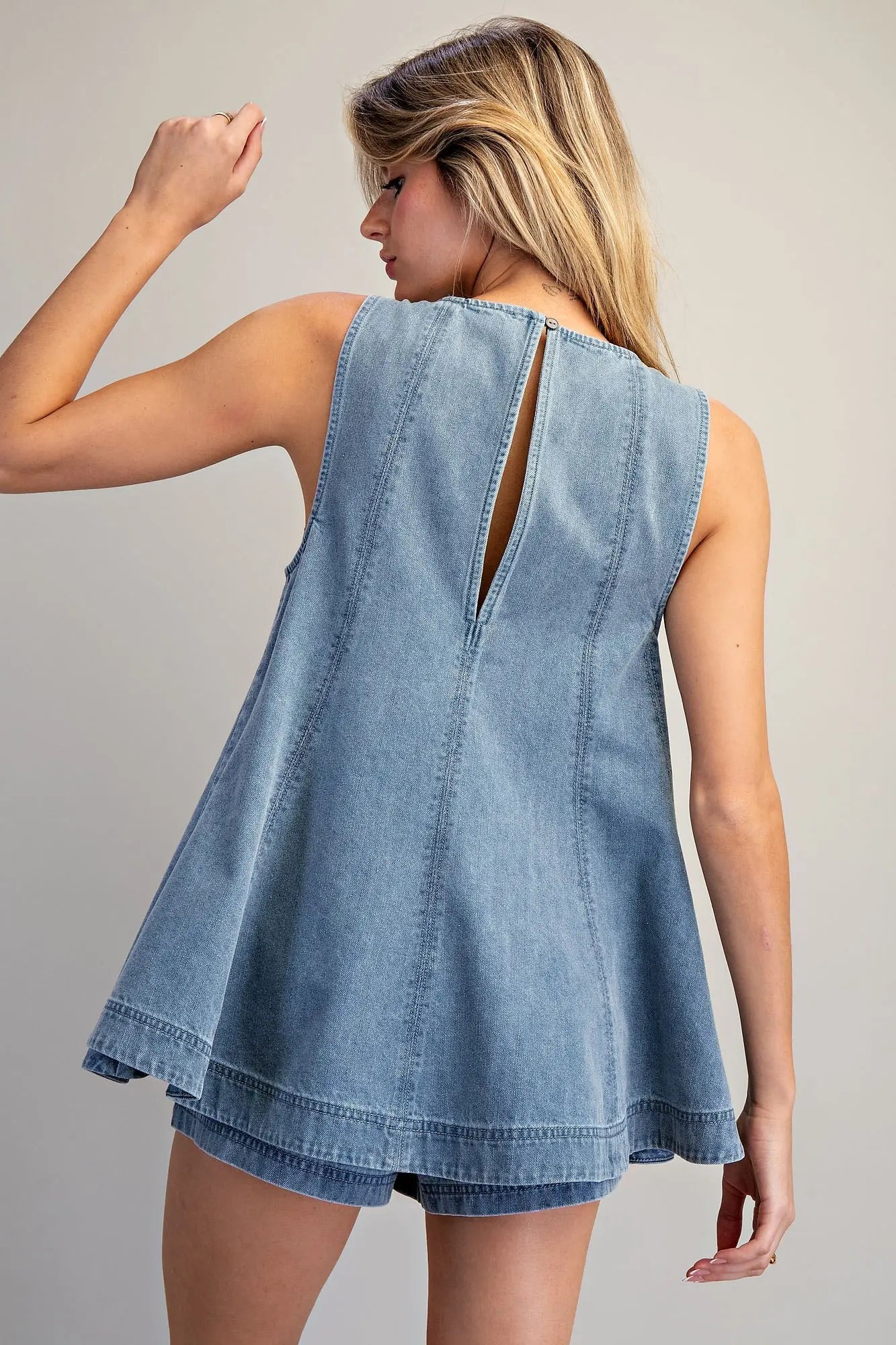 Sleeveless A-line denim top with high neckline