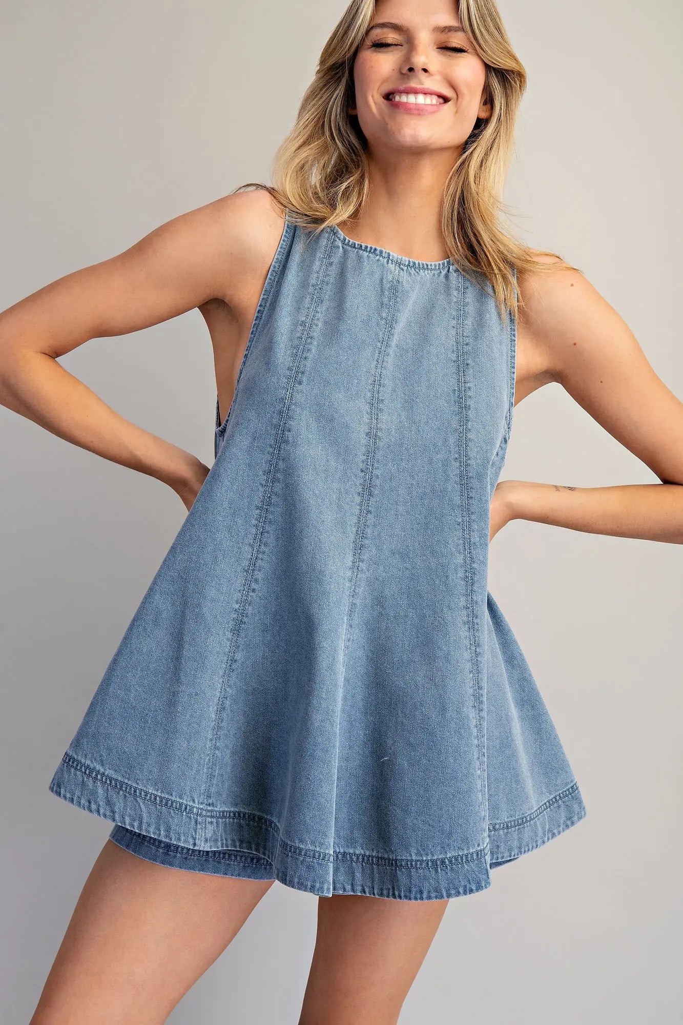 Sleeveless A-line denim top with high neckline