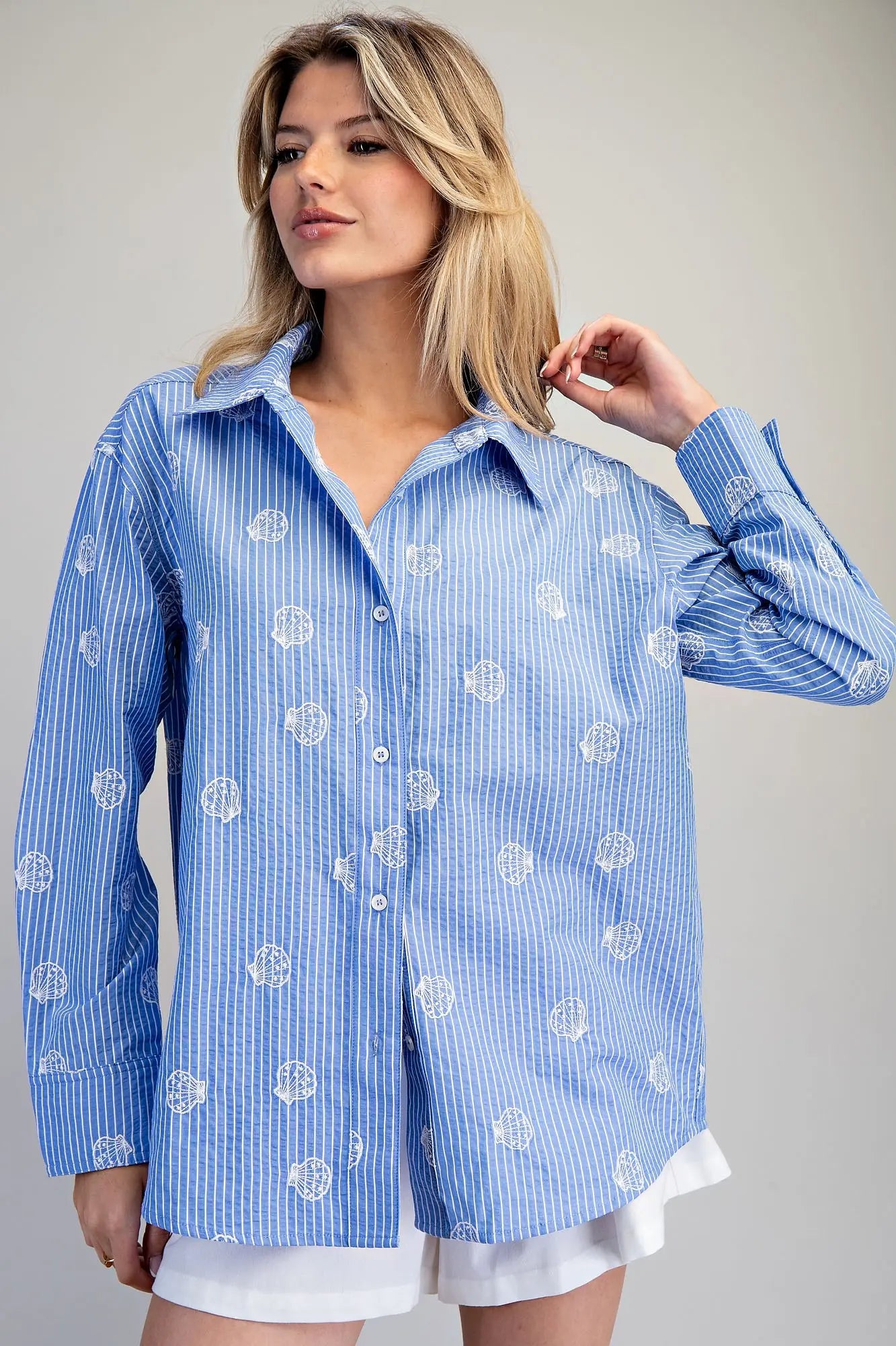 Blue and white striped button down shirt with seashell embroidery