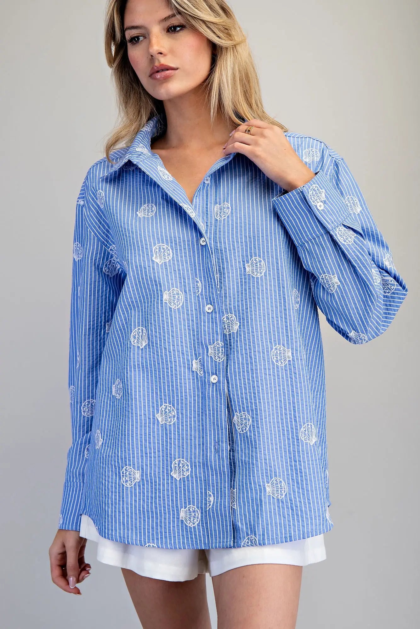 Blue and white striped button down shirt with seashell embroidery