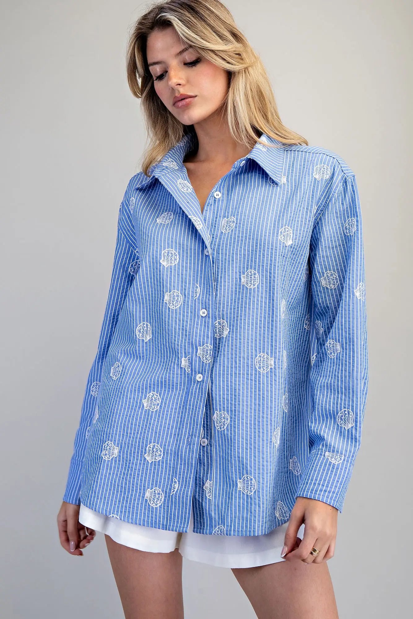 Blue and white striped button down shirt with seashell embroidery
