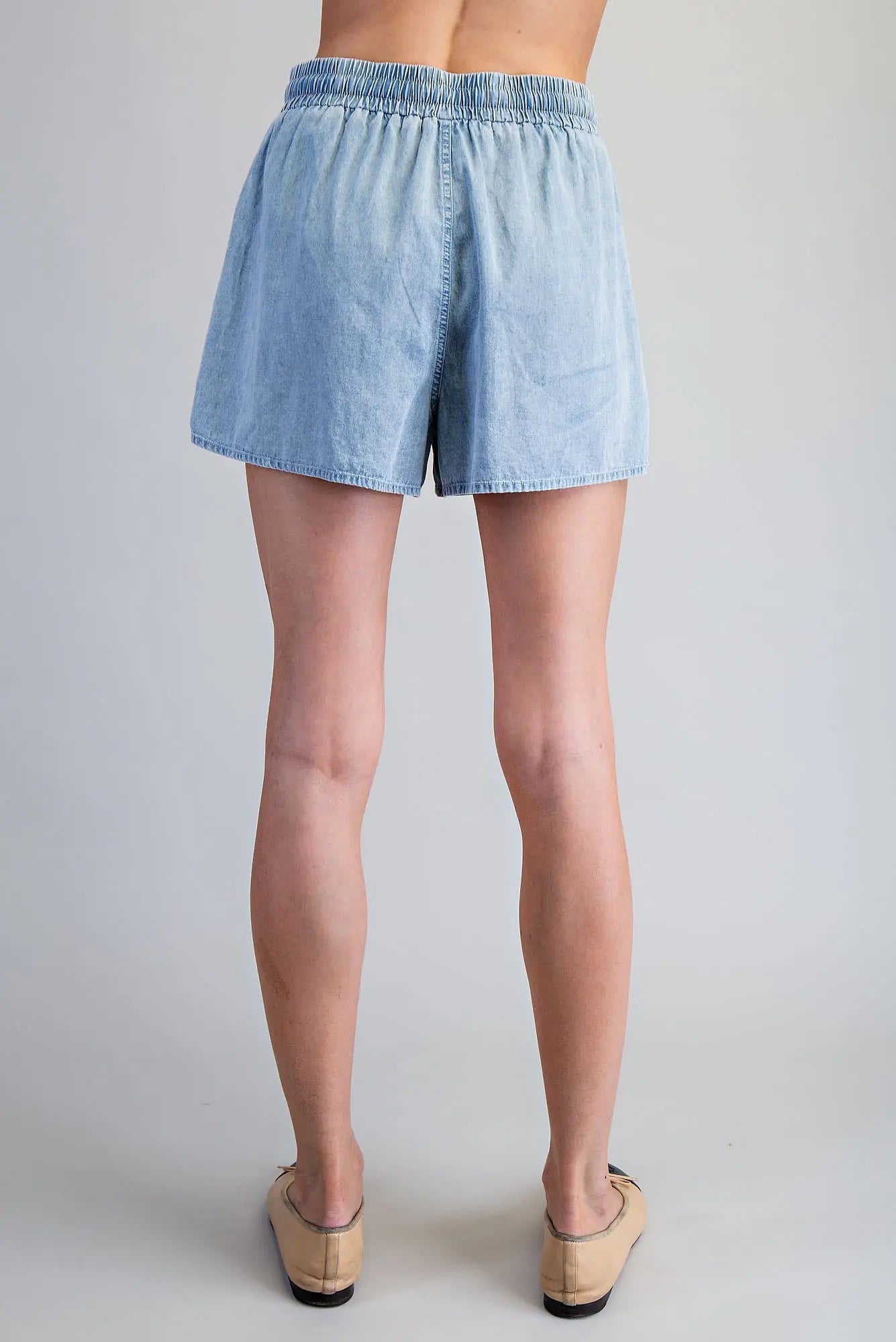Snow washed drawstring shorts with zigzag trim pocket detail and relaxed fit, styled for a casual everyday look.