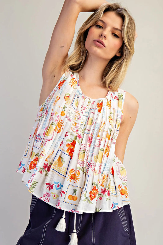  Pleated Blouse features a vibrant fruit and floral patchwork print with soft pleating and a breezy swing 