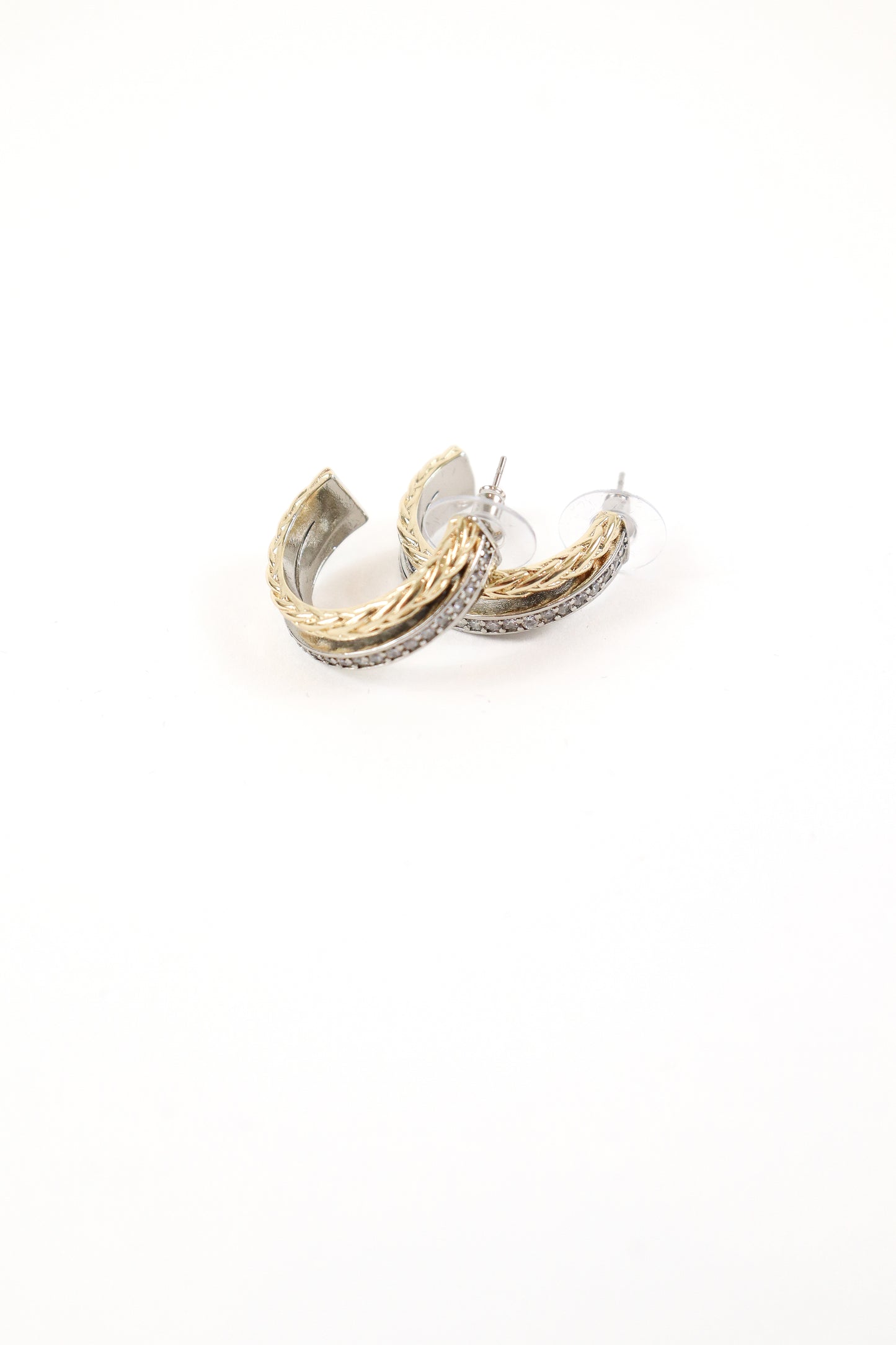 Mixed metal braided hoop earrings with gold texture and crystal detailing
