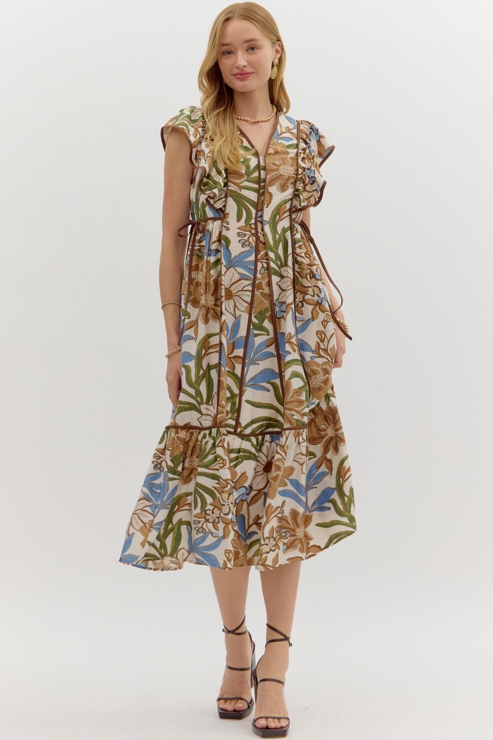 A botanical print flutter sleeve midi dress with a ruffle hem and adjustable side waist tie.

