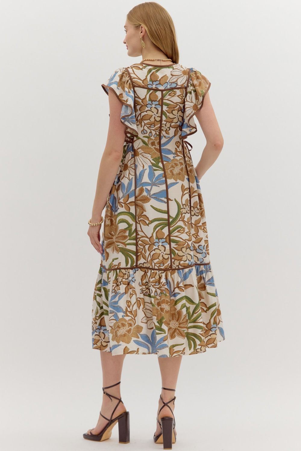 A botanical print flutter sleeve midi dress with a ruffle hem and adjustable side waist tie.

