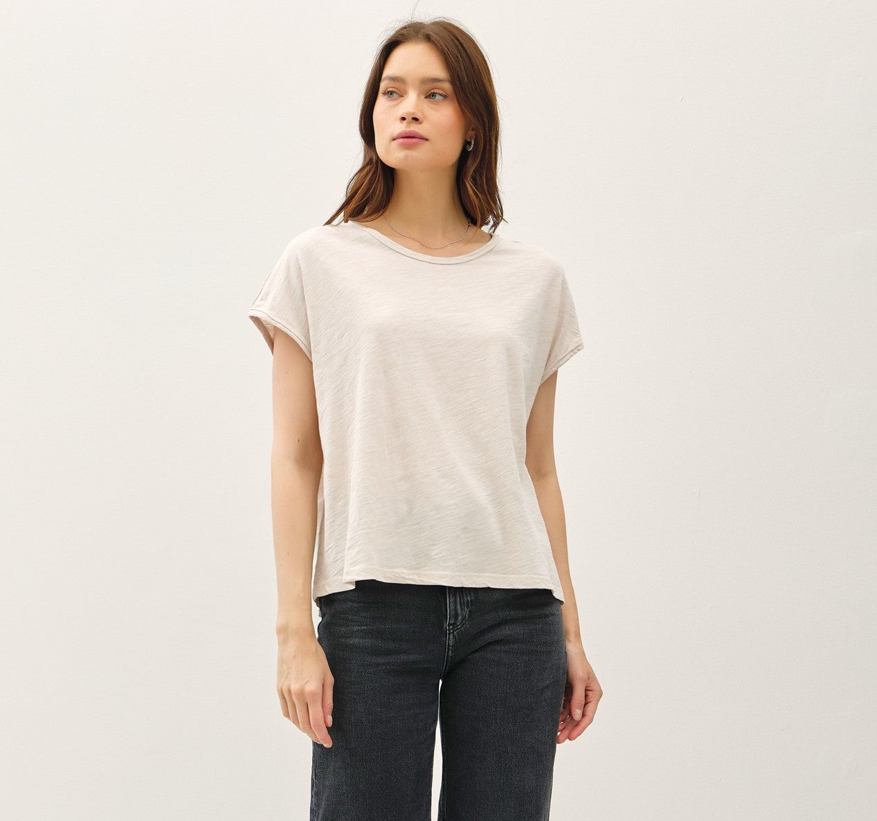 A boxy-fit cap sleeve tee with raw seams and a modern, relaxed silhouette.
