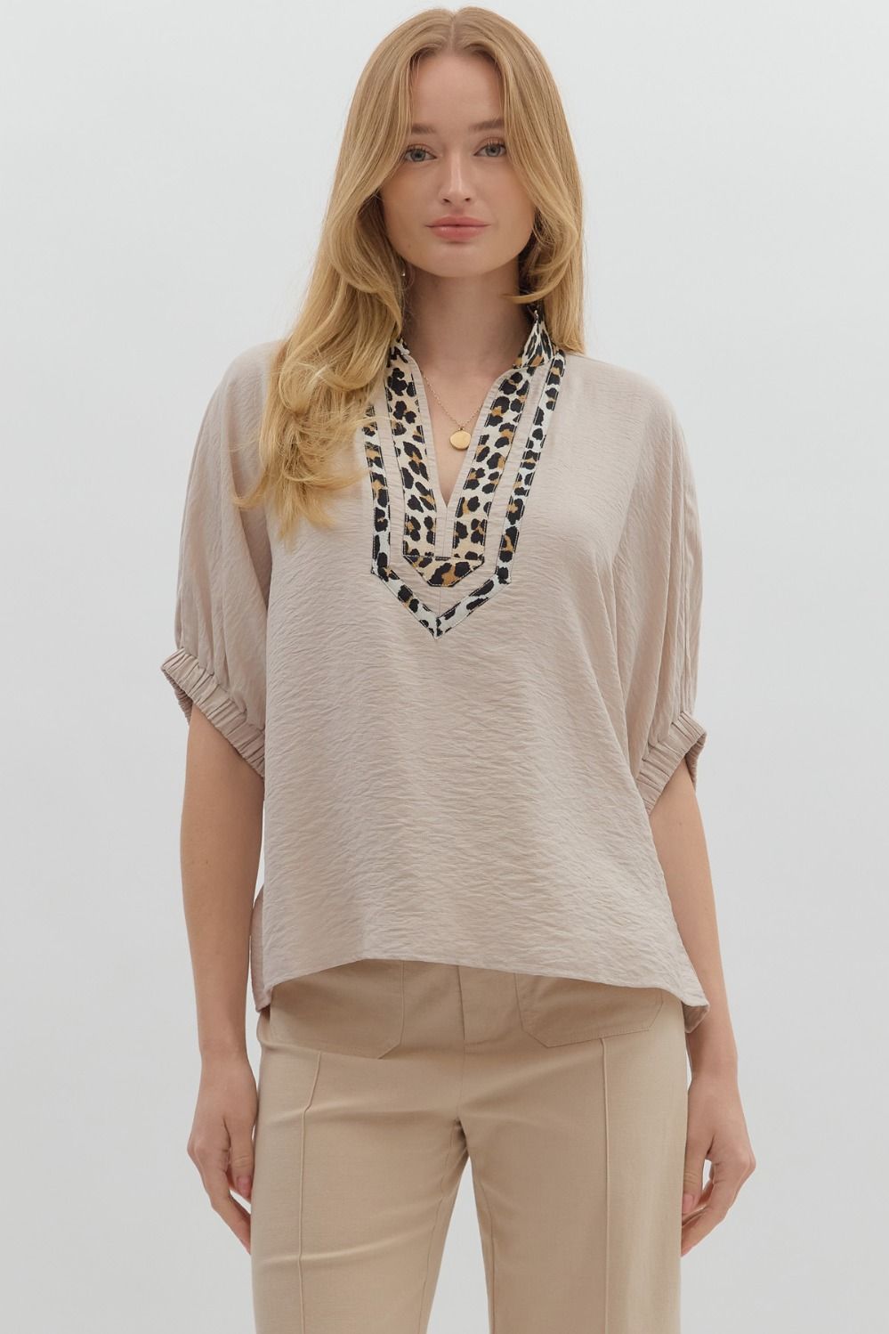 A breezy dolman top with leopard print accents and a caftan-inspired neckline.